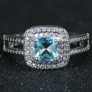 SILVER PINK AND WHITE HALO SQUARE BLUE STONE RING